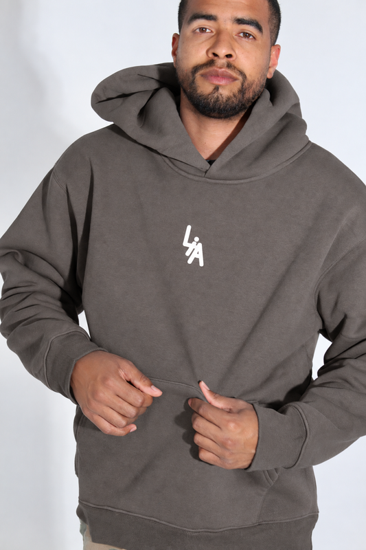 Angled front pose with gray hoodie